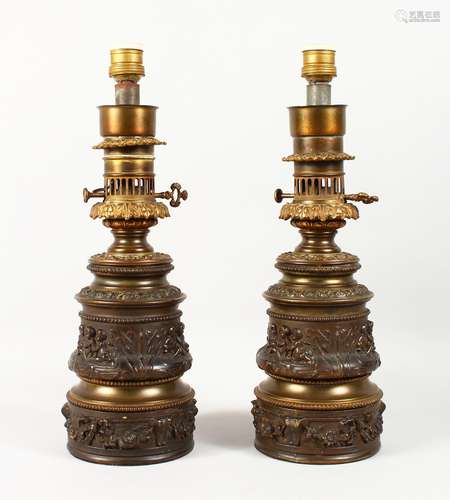 A GOOD PAIR OF 19TH CENTURY FRENCH BRONZED LAMPS with classical cupid decoration. 15ins high.