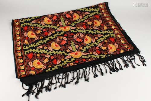 A CREWEL WORK STYLE EMBROIDERED SHAWL, black ground with floral decoration. 186cms x 70cms.