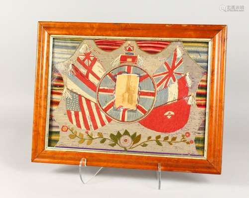 A MARITIME WOOLWORK PICTURE, depicting a photograph of a sailor within embroidered flags, framed and