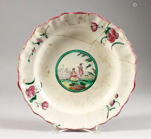 AN 18TH CENTURY DELFT TIN GLAZED SHAPED DISH, painted to the centre with two musicians (AF). 9.