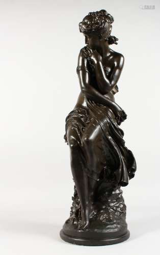 MOREAU A BRONZE-LIKE FIGURE OF A SEATED SEMI-NUDE YOUNG LADY, on a circular base. Signed. 25ins