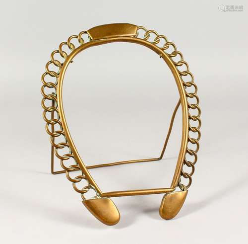 A BRASS HORSESHOE SHAPED PHOTOGRAPH FRAME. 12ins high.