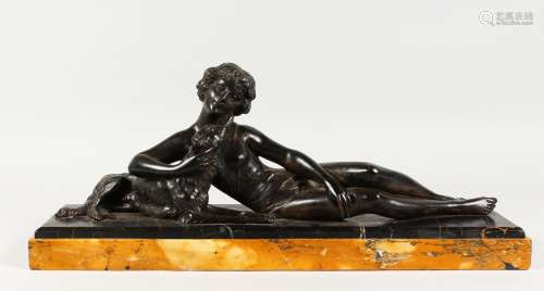 AN ART DECO PATINATED SPELTER GROUP, of a reclining woman with a dog, on a marble base. 21.75ins
