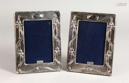 A PAIR OF SILVER ART NOUVEAU DESIGN PHOTO FRAMES. 7.25ins x 5.5ins.