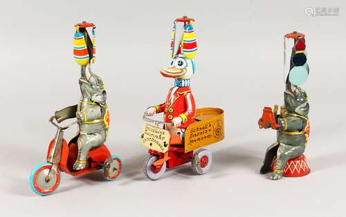 A GROUP OF THREE GERMAN TINPLATE TOYS, modelled as animal circus acts. 7.5ins high.