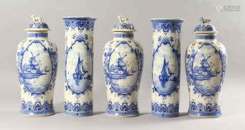 A DUTCH DELFT FIVE PIECE GARNITURE, comprising three baluster shaped vases and covers, and a pair of