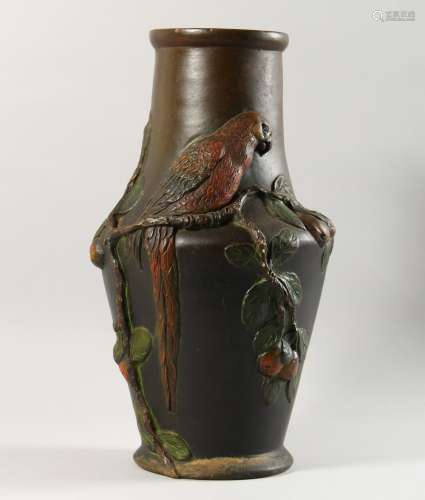 A CONTINENTAL PAINTED TERRACOTTA VASE, with moulded decoration of a parrot on a branch. 16ins high.