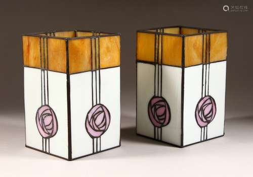 A PAIR OF MACKINTOSH STYLE STAINED GLASS LIGHT SHADES. 8.75ins high.