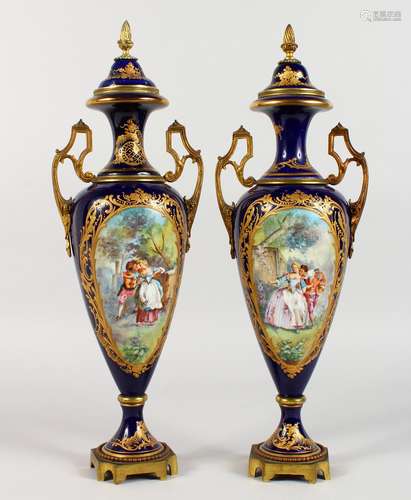 A SUPERB PAIR OF DARK BLUE GROUND SEVRES TWO-HANDLED URNS AND COVERS, with gilt decoration and