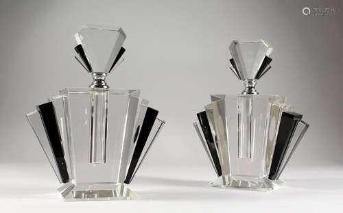 A PAIR OF ART DECO PLAIN AND BLACK SCENT BOTTLES AND STOPPERS.