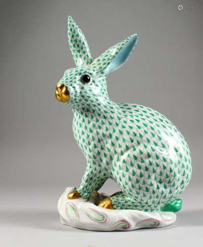 A HEREND LARGE PORCELAIN MODEL OF A RABBIT, seated on a moulded base. 12ins high.