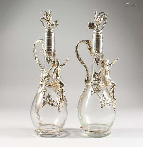 A GOOD PAIR OF GLASS CLARET JUGS AND STOPPERS, with applied plated mounts, cupids and fruiting