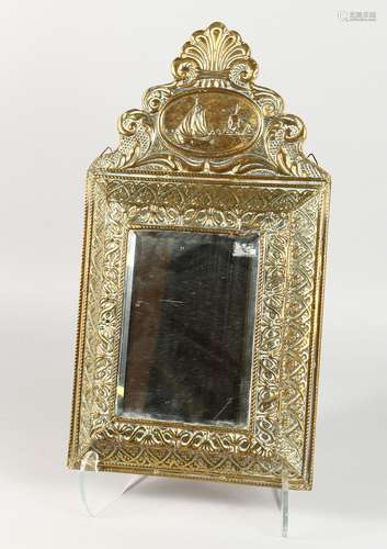 AN EMBOSSED BRASS HALL MIRROR, the hinged front enclosing two brushes. 19ins high x 10.5ins wide.