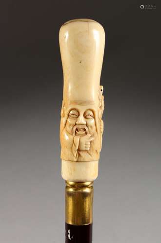 A VERY GOOD CHINESE CARVED BONE HANDLED WALKING CANE, head of a man with turtle. Handle: 5ins long.