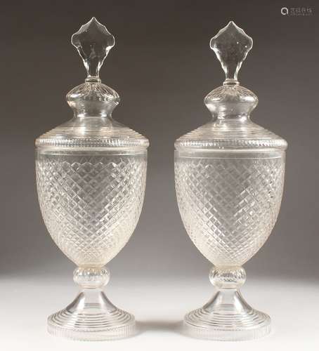 A LARGE PAIR OF HOBNAIL CUT GLASS URNS AND COVERS.