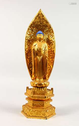 A CARVED GILTWOOD BUDDHA, with blue hair, on a throne. 14ins high.