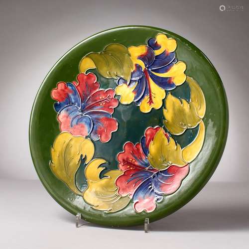 A LARGE MOORCROFT CIRCULAR GREEN GROUND PLATTER, 