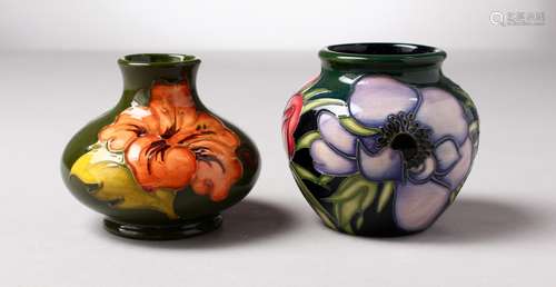 TWO SMALL MOORCROFT HIBISCUS BULBOUS VASES, one dated 2003. 3ins high (2).