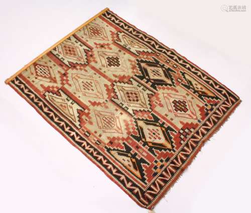 AN AFGHAN KELIM CARPET, of typical form. 7ft 5ins x 5ft 10ins.