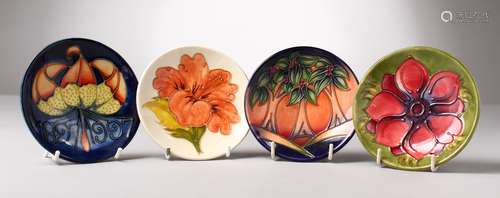 FOUR SMALL VARIOUS MOORCROFT CIRCULAR SAUCERS. 4.5ins diameter.