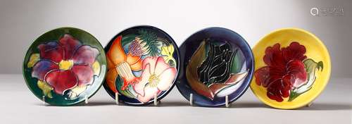 THREE SMALL VARIOUS MOORCROFT CIRCULAR SAUCERS AND A BOWL. 4.5ins diameter. (4).