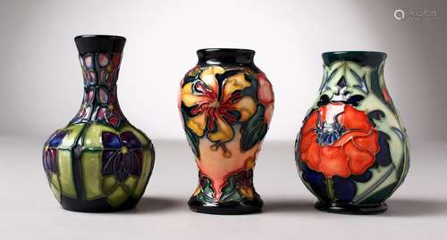 THREE SMALL VARIOUS MOORCROFT VASES. 4ins high.