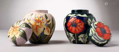 TWO SMALL MOORCROFT POTTERY GINGER JARS AND COVERS. 4.5ins high.