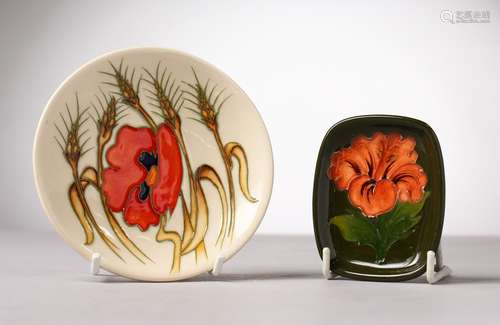 A SMALL MOORCROFT POTTERY SAUCER and A DISH.