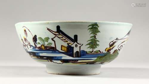 A 19TH CENTURY DELFT BOWL, painted in blue, yellow and manganese. 9in s diameter.