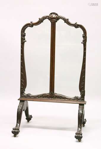 A GOOD 19TH CENTURY CARVED MAHOGANY FOLDING SCREEN, with three glazed panels on four curving legs,