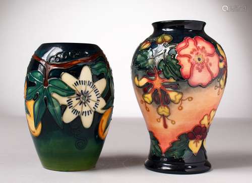 TWO MOORCROFT POTTERY VASES, blue ground with flowers. 6.5ins and 5.5ins high.