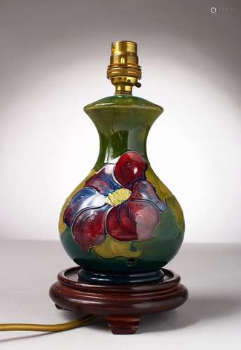 A MOORCROFT POTTERY LAMP with shade and base.