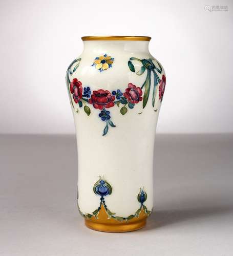 A MOORCROFT POTTERY MACINTYRE VASE, garland of roses and ribbons. Script signature W. Moorcroft in