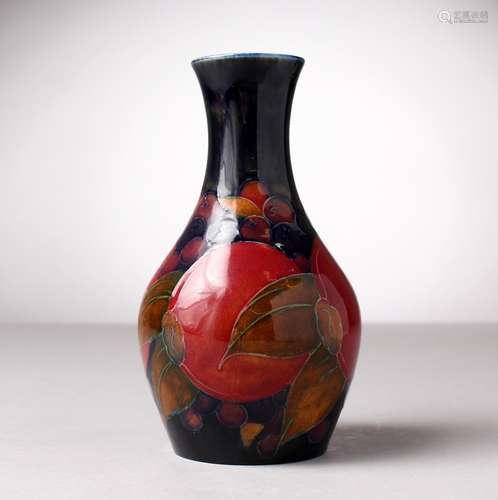 A MOORCROFT POTTERY BULBOUS VASE, blue ground with pomegranates and fruit. Impressed MOORCROFT, W.