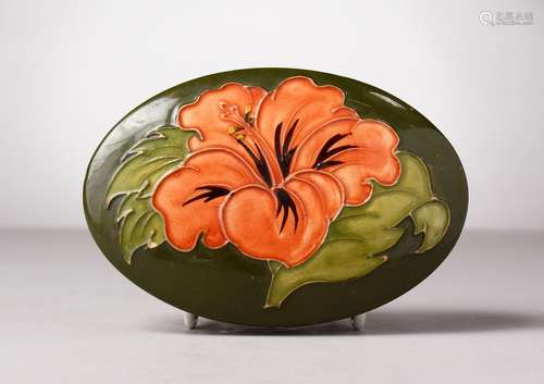 A MOORCROFT POTTERY GREEN GROUND OVAL BOX AND COVER. Impressed MOORCROFT. 5.25ins long.