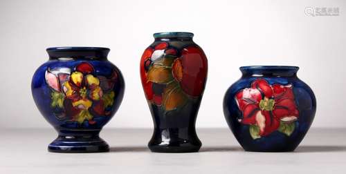 THREE VARIOUS SMALL MOORCROFT POTTERY VASES, blue ground with flowers and fruit. Two with W.