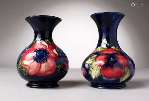 TWO MOORCROFT POTTERY VASES, blue ground with pansies and anemones. W. Moorcroft and WM initials (