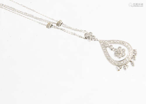 An 18ct white gold diamond set pendant and necklace, the tear shaped necklace of openwork design