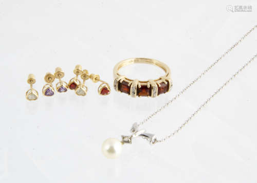 A 14ct gold diamond and cultured pearl drop pendant, a 9ct gold garnet and diamond dress ring, and