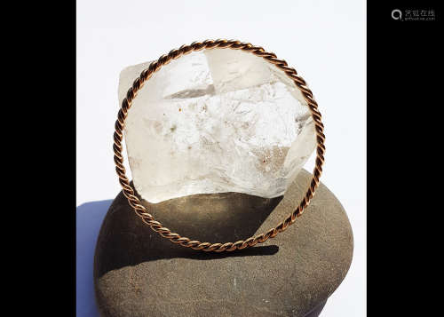 A yellow metal rope twist circular fixed bangle, interior dimensions 6.2cm diameter, 12g
