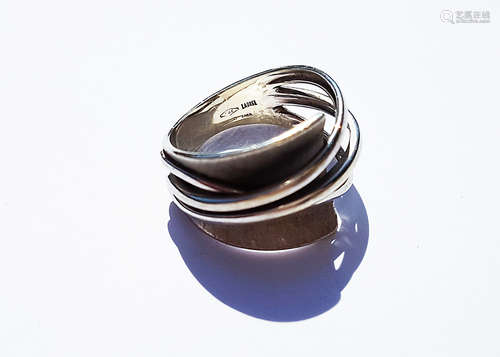 A contemporary 9ct white gold dress ring, by Laurel, the crossover design with three pierced bands