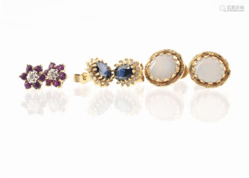 A pair of 18ct gold sapphire and diamond stud cluster earrings, the oval mixed cut sapphire