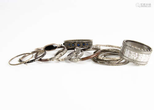 A collection of silver, white metal and base metal bangles, including an enamel and seed pearl