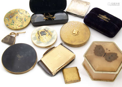 A small collection of lady~s compacts, including one with a painted top depicting Pekinese signed