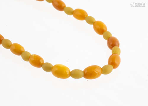 A string of Baltic amber and vegetable ivory beads, the oval amber beads alternately strung with