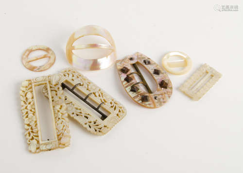 A collection of mother of pearl buckles, including two floral carved examples, another of buckle