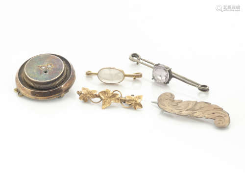 A collection of 19th Century brooches, including a moonstone safety pin example, an amethyst bar