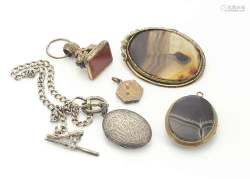 A 19th Century silver oval Mizpah locket, with leaf engraved decoration, together with an oval