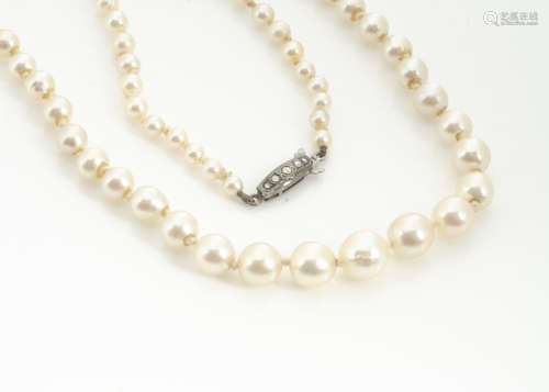 A string of graduated cultured pearls, the knotted strung necklace with a continental 935 and