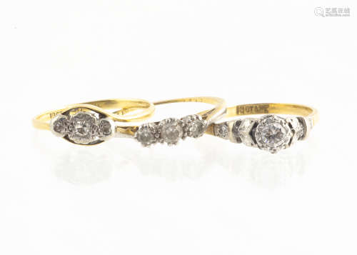 An 18ct gold platinum set diamond solitaire, the raised setting with stylised leaf decoration and